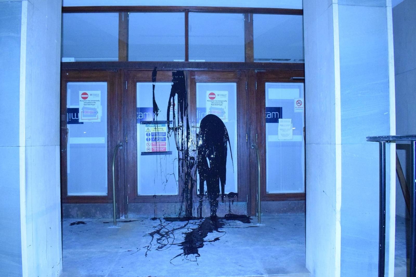 Black paint was thrown over the front doors of the University of Cambridge Chemistry Department by protestors.