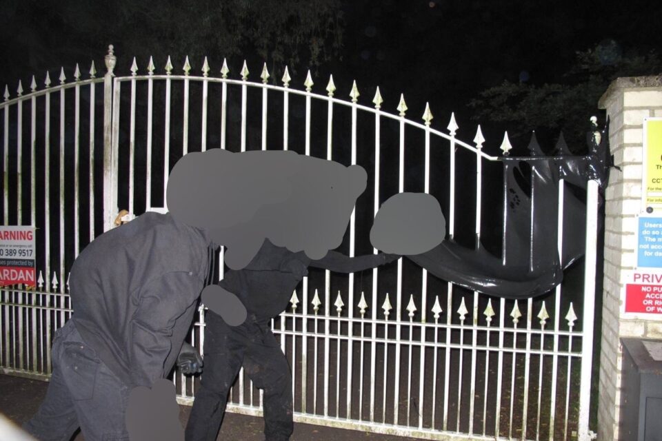 Protestors throw black paint over the gate of Milton Hall, host to oil company supplier ProTechFlow solutions.